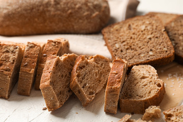 Composition with bakery products, salt and kitchen towel on white background, closeup and space for text