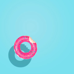 Top down aerial view of summer float doughnut inflatable toy in pool. Summer vacation concept.