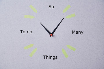 Time management deadline and schedule concept: hand made clock on grey background
