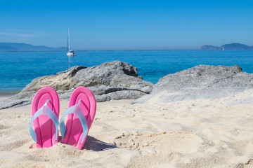 sandals in the sand of the beach, summer and holidays