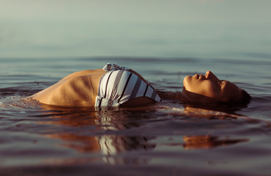 Beautiful woman lying in the water