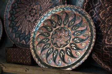 Copper plate handcrafted, traditionally made in Lagich, Azerbaijan. Handmade plate in souvenir shop.