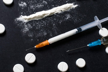 Hard drugs on dark table. heroin, cocaine, amphetamine, ecstasy, pills and more. Creative idea....
