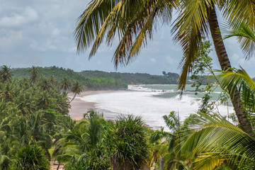 Fototapeta na wymiar View of the Axim coast in Ghana which is an untouched nature and can walk on the beach for long periods without meeting anyone.