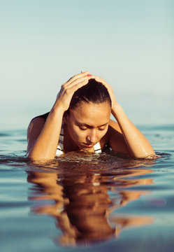 Portrait of a beautiful woman getting out of the water