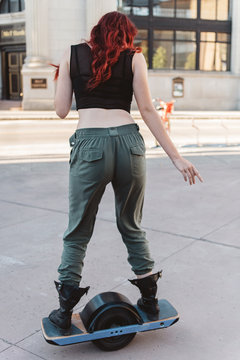 A teenage girl hanging out in the city at sunset