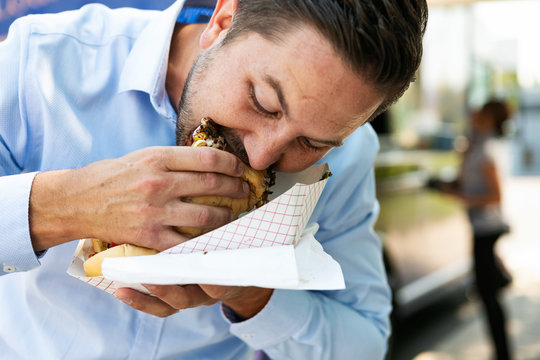 Food Truck: Customer Having A Hard Time Eating Large Sandwich