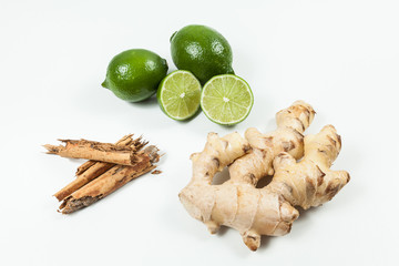 Ginger root with lemon and cinnamon photo on neutral background