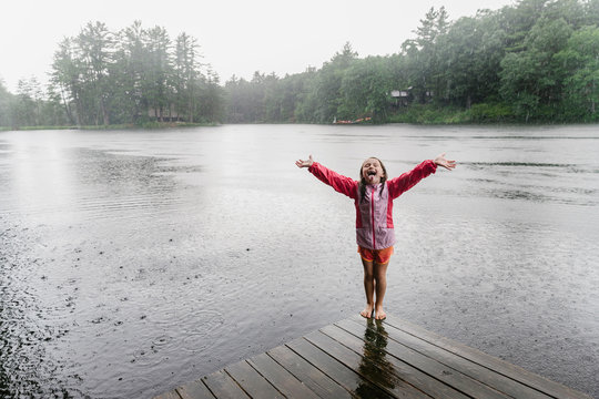 Child Playing in Pouring Rain