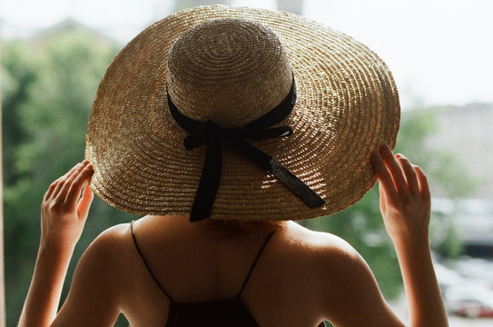 Back view of a woman with straw hat