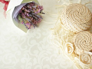 floristry and gardening concept. a bouquet of dried flowers in paper and three wicker beige boxes on a light background. top view. copy space for text.