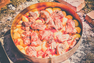 Lamb meat, potatoes and vegetables cooked on a grill, Serbian dish 