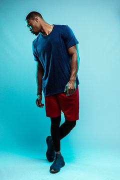 Black athlete looking down with legs crossed