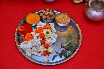 Maharashtrian Wedding Ritual - Seeman Puja - Closeup of a big plate (Thali)  decorated with auspicious items like kumkum,haldi,betel nuts, akshada and flowers for Puja