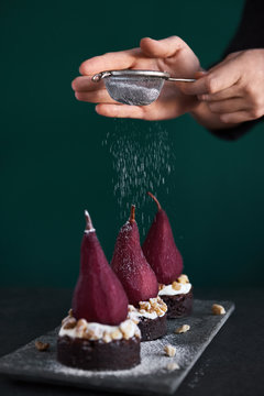 Chef adding finishing touches on pear dessert