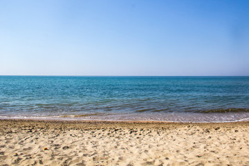 Fototapeta na wymiar Seascape of sand shore and waves of Black sea