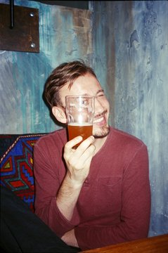 Portrait of a guy in a cafe with a glass of beer