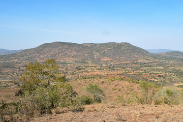 Fototapeta na wymiar Beautiful mountain ranges in the panoramic arid landscapes of rural Kenya, Kilome Plains in Eastern Kenya