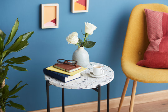 Cozy home with flowers on table and chair.
