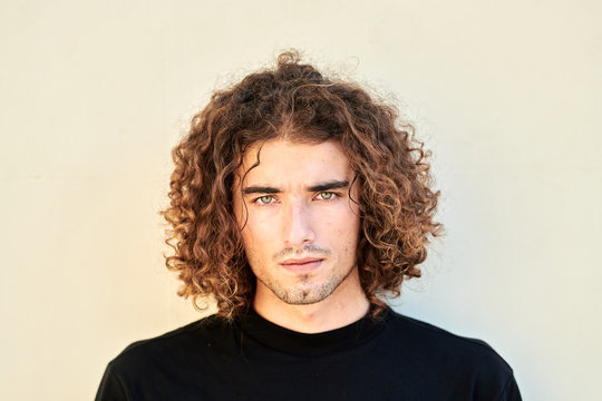 Handsome man with curly hair.