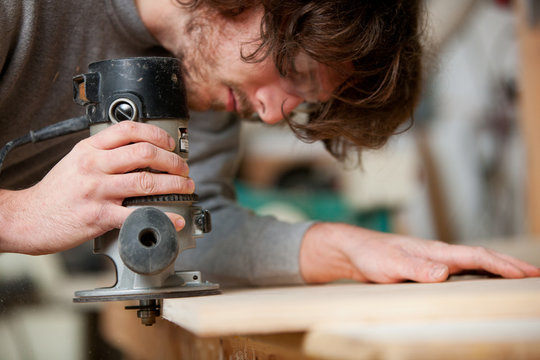 Woodworking: Man Routing Out Holes For Biscuits - Powered by Adobe