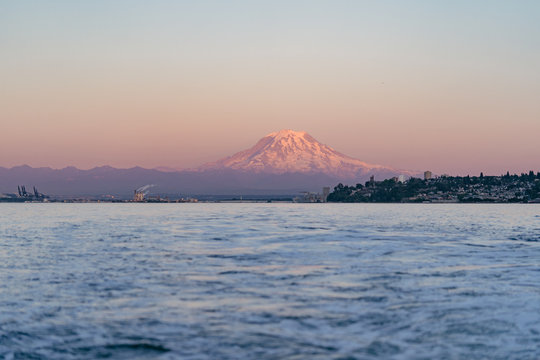 Colorful sunset with Mount Rainier over the waters of the Puget Sound in the Pacific Northwest.