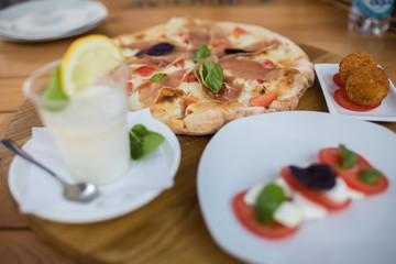 Italian pizza with jamon, basil, cheese and tomato. Food concept