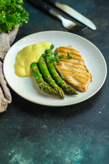 asparagus and chicken meat, breast fillets grill, hollandaise sauce. food background. top