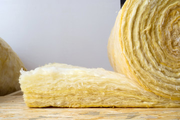roll of mineral wool lying on the wooden floor