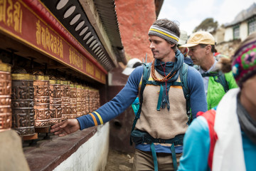 Traveler Spins Traditional Buddhist Prayer Wheels