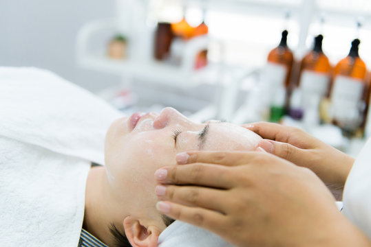 Woman receiving face and scalp massage