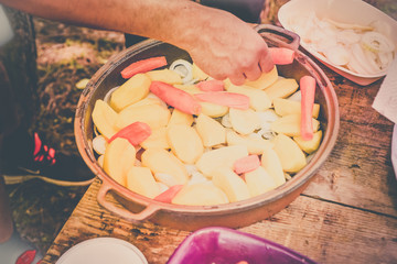 Lamb meat, potatoes and vegetables preparing for cooked on a grill, Serbian dish 