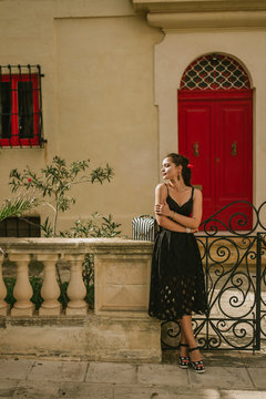Portrait of a young beautiful woman walking in old town