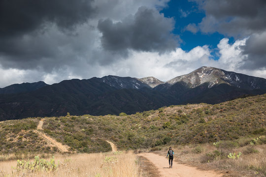 Person hiking with impending storm.