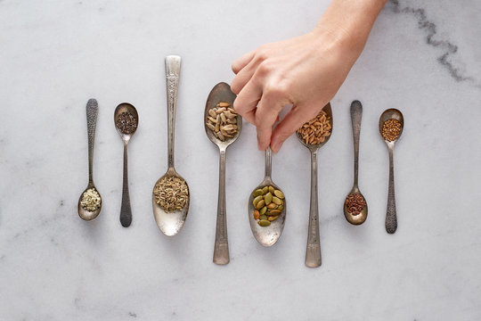 Organic Edible Seeds in Spoons on a Counter