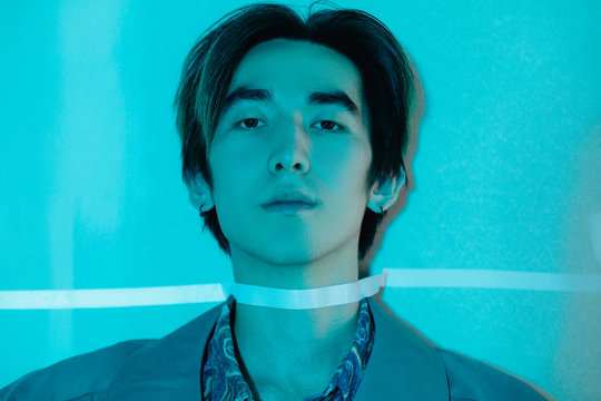 Asian man taped to wall