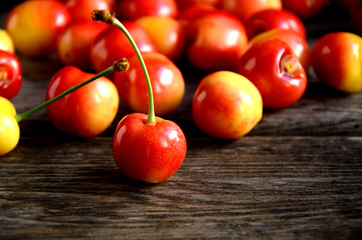 Cherry scattered on wooden boards.