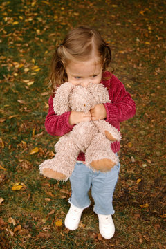 family at a picnicLittle girl with plush toy in an autumn park