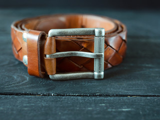 leather vintage brown belts on dark wooden background
