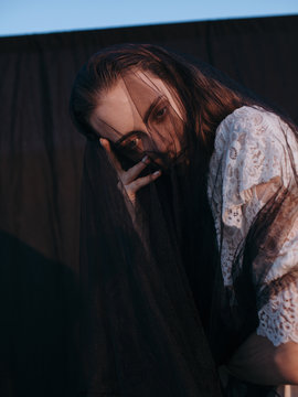 Young woman in transparent veil