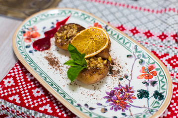 Sugar dessert wuth mint, lemon, nuts ant cooked peaches on beautiful plate. Food , menu concept