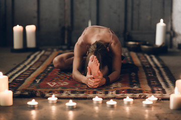 Woman in asana on carpet
