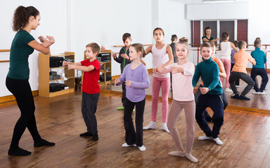 children  studying folk style dance in class