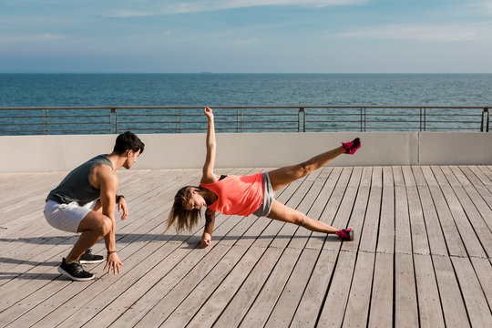Fit couple jogging in the city - Powered by Adobe