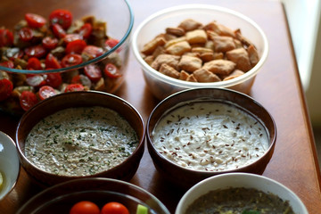 Table setting with galette, snacks, dips and salads. Selective focus.