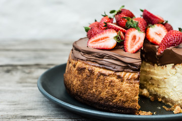cheesecake with chocolate and strawberry topping