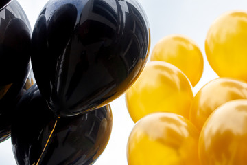 A background of black and gold balloons