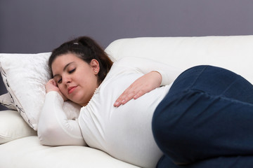 Tired Expectant Mom Sleeping on the Couch