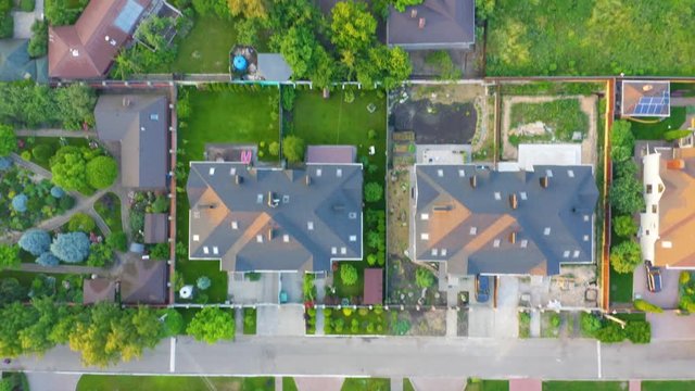 Aerial top view of residential neighborhood with the homes in suburbs at sunset