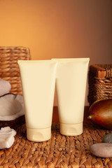 SPA composition on wooden background. Set of copyspace cosmetic bottles and tubes with coconut. Face or body care concept: body lotion, cream, gel, soaps, serums and oils flask.